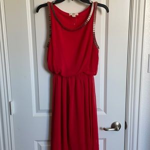 Red high low dress with gold chain detail design